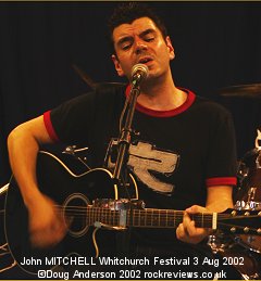 John Mitchell alone with just an acoustic guitar for company